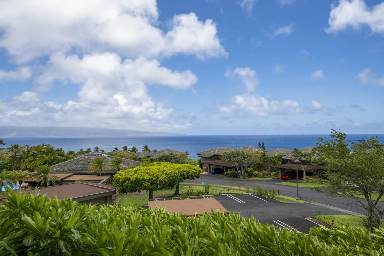 View from Kapalua Ridge Villa 812 across resort rooftops to the ocean, with the island of Molokai on the horizon.